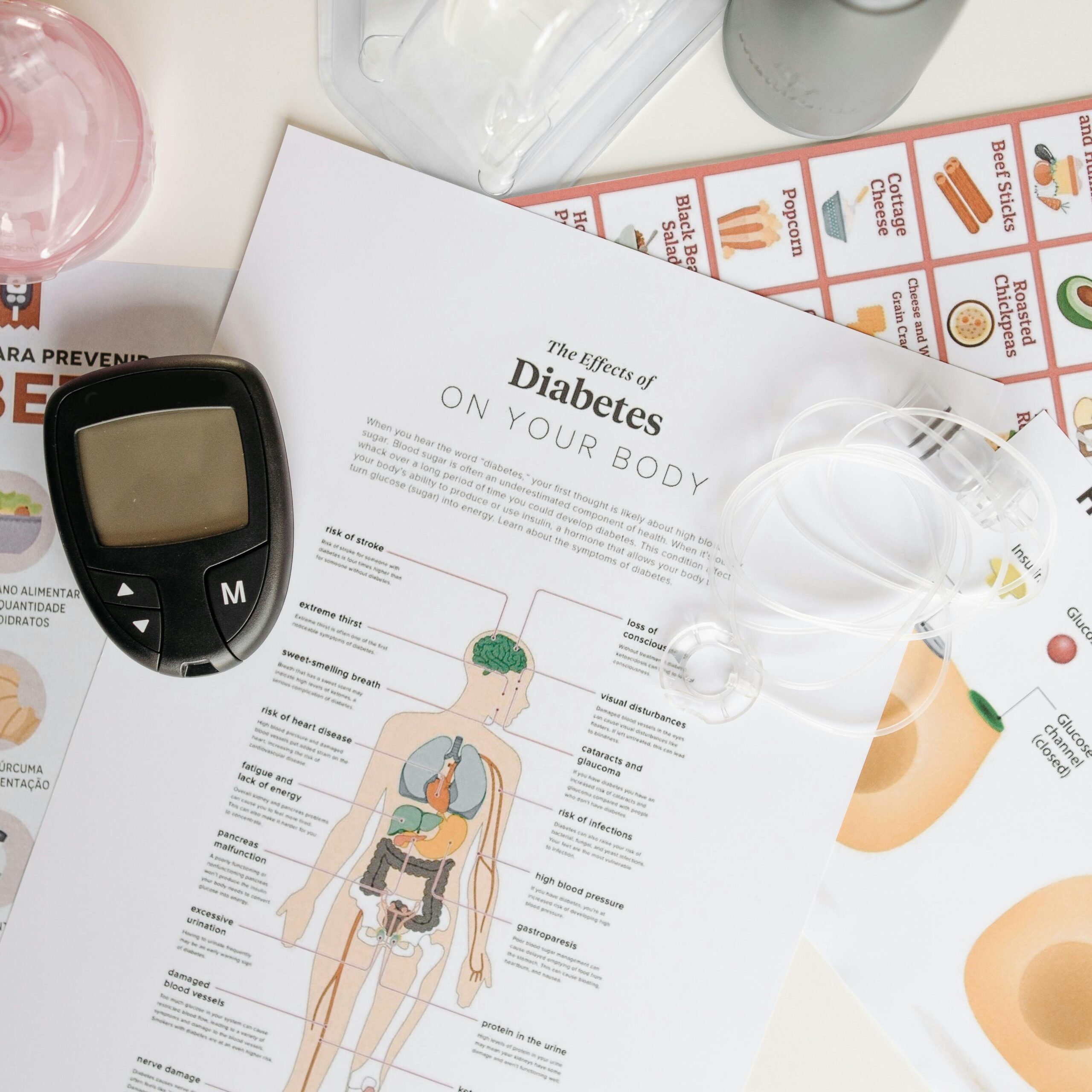 Close-up of diabetes management tools and informational documents on a table.